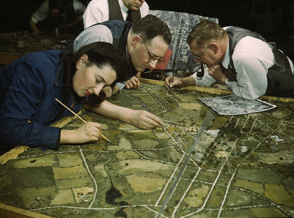 3 Map Makers working on a map