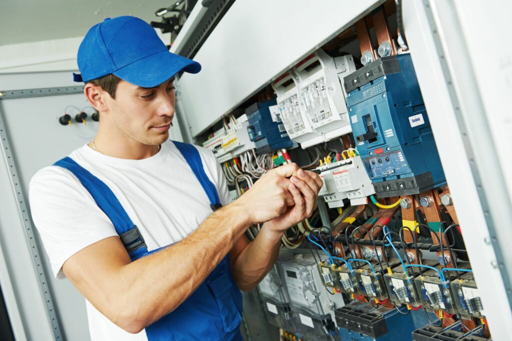 Automation Systems Technician working at a control panel