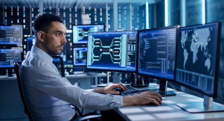 IT technician looking at monitors