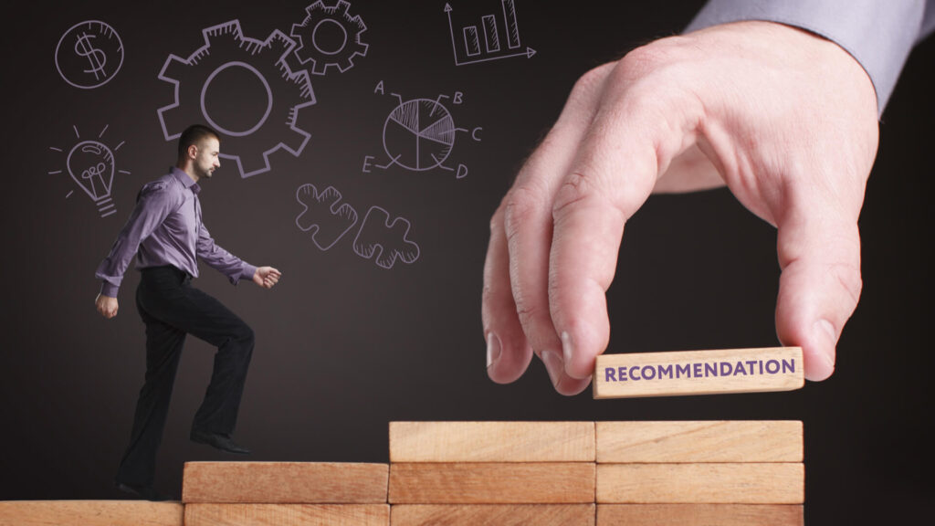 a person stepping up on wooden blocks moving toward a hand placing a block titled recommendation