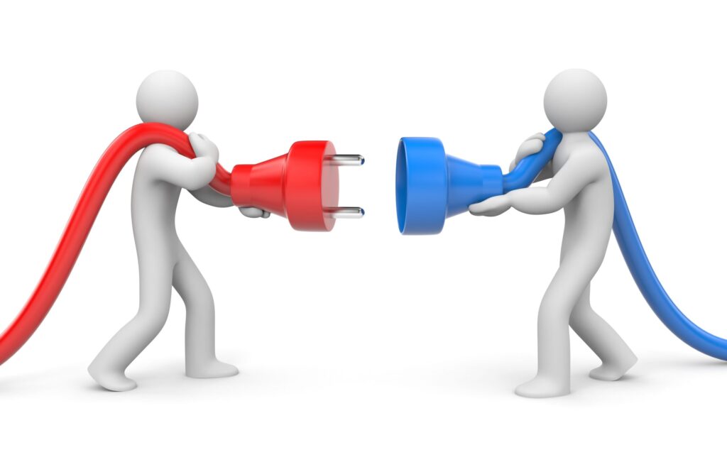 Two white 3D rendered human figures attempt to connect electrical plugs against a white background. The figure on the left holds a red electrical plug with a red cord, while the figure on the right holds a blue electrical socket with a blue cord. Both figures are positioned as if trying to plug the red connector into the blue socket, symbolizing connection, collaboration, or the joining of different systems or ideas. The minimalist style emphasizes the concept of making connections or partnerships.